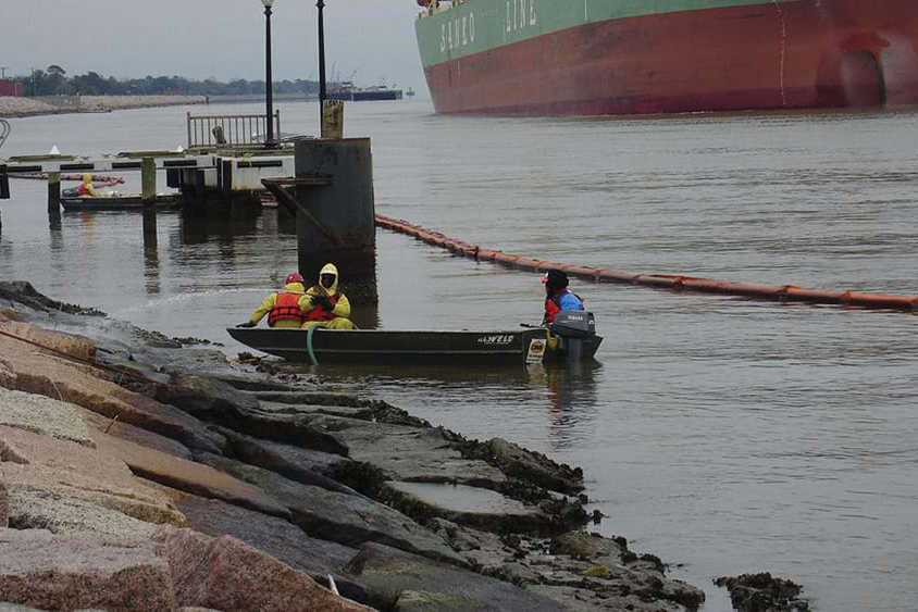 Workers clean oil from the rocks following a spill in Port Arthur, Texas in January 2010.