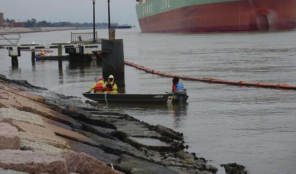 Workers clean oil from the rocks following a spill in Port Arthur, Texas in January 2010