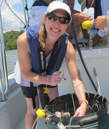  Erica Seiden, NOAA’s Office for Coastal Management manager for the Ecosystems Program and the National Estuarine Research Reserve System, participating in shark tagging at Rookery Bay, Florida. 