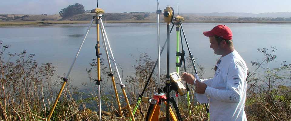 A geodesist using measuring equipment