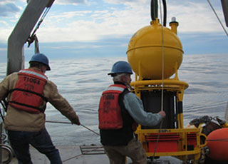 Scientists deploy an Environmental Sample Processor to detect toxic Alexandrium blooms in the Gulf of Maine. 
