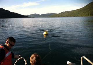 NOAA water level buoy being deployed in Terror Bay, Alaska.