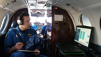 LT Scott Broo acquiring aerial imagery aboard the NOAA King Air aircraft.