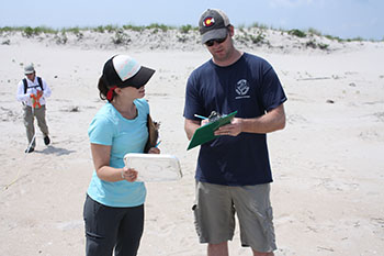 NOAA Marine Debris Program staff conduct a shoreline marine debris survey as part of the NOAA Marine Debris Monitoring and Assessment Project. Image credit: NOAA