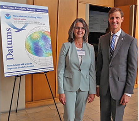 NGS Director Juliana Blackwell pictured with the 2019 Geospatial Summit’s Keynote speaker, RDML Timothy Gallaudet, PhD, USN Ret., Assistant Secretary of Commerce for Oceans and Atmosphere and Deputy NOAA Administrator next to a poster that says 'Datums.'