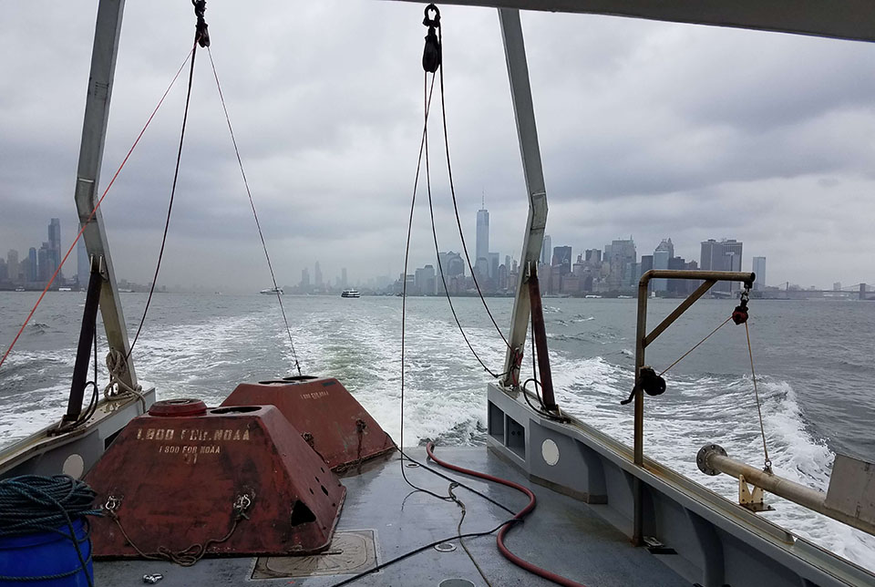 View of the Manhattan skyline from a vessel on the Hudson River. Two NOAA sensors are in view on the vessel.