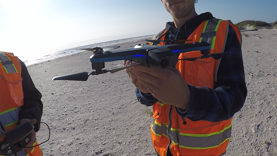 A researcher holds an aerial drone.