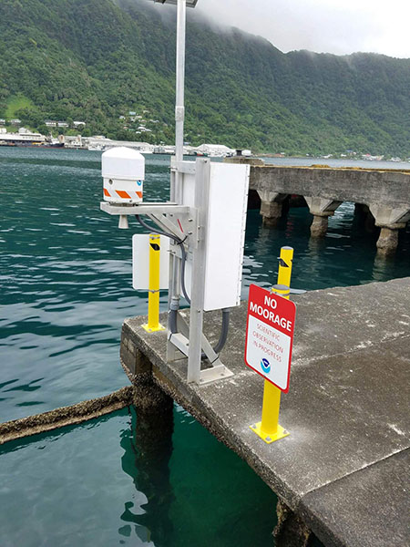 Water level monitoring equipment on a concrete dock.