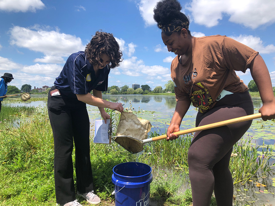 Teachers sample a local pond to determine the health of the water during the July 2023 NOAA Planet Stewards summer workshop 