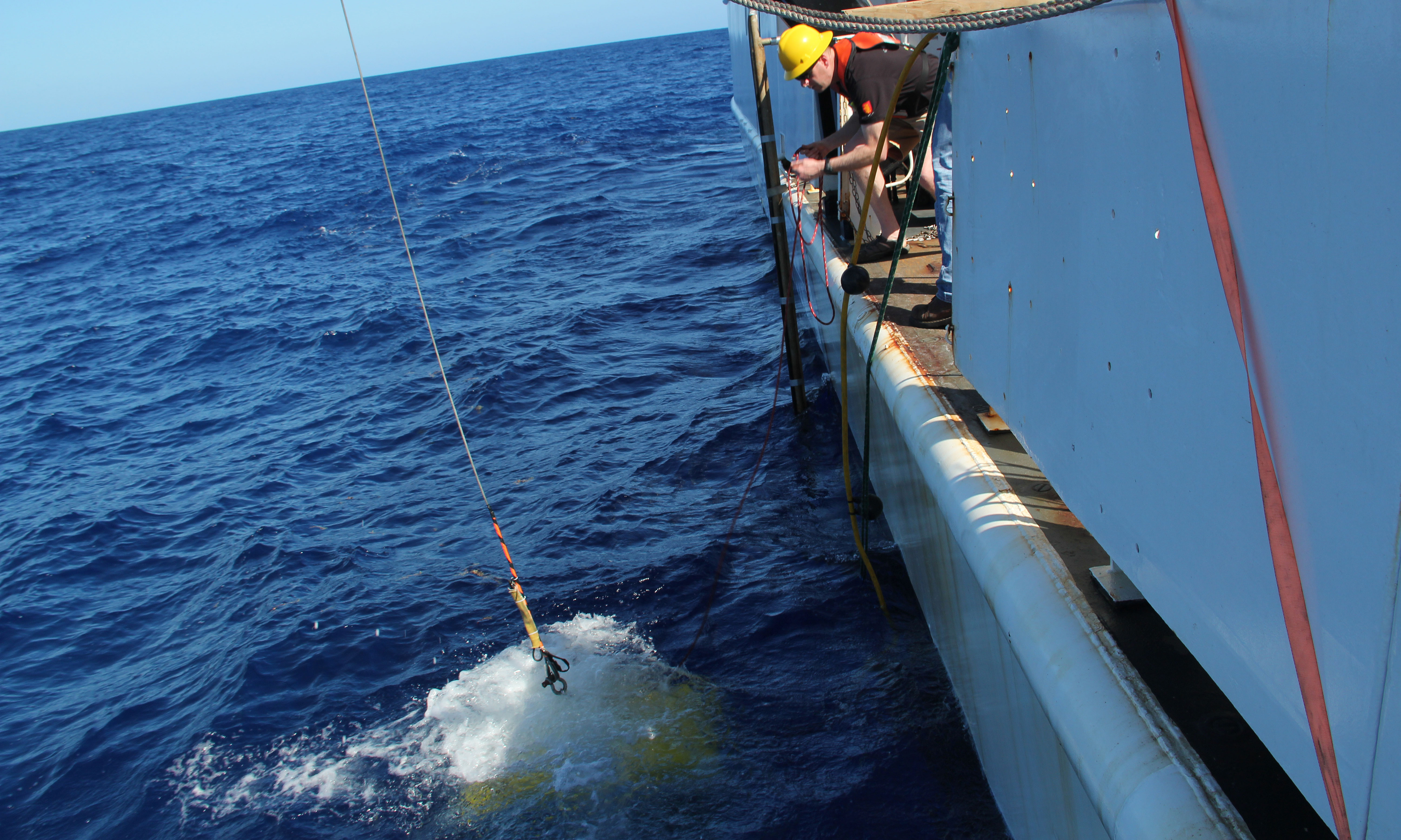 Oceanographer Tim Battista looks on as the ROV splashes into the ocean.