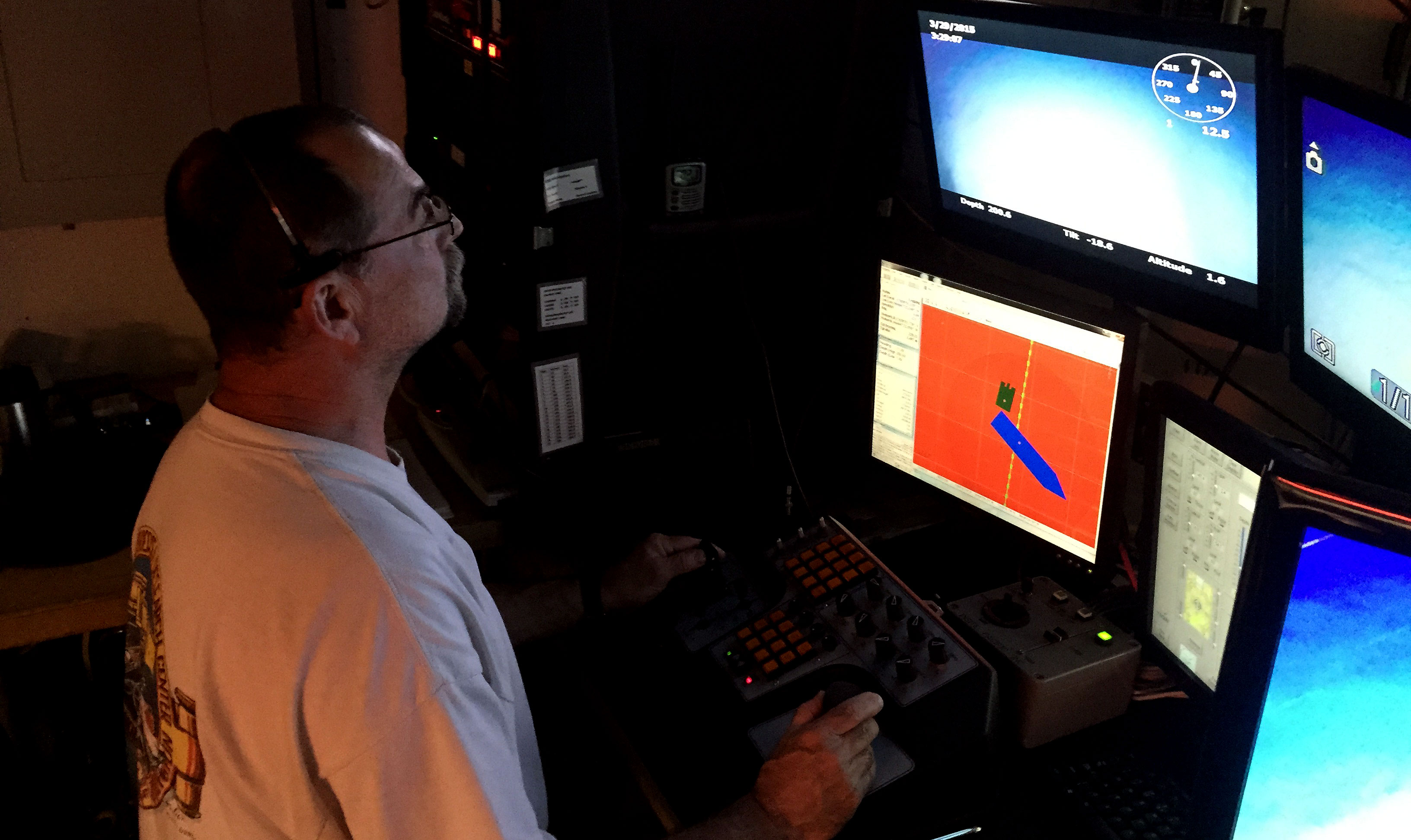 Once the ROV is safely away from the ship, ROV technician Lance Horn drives the ROV to the seafloor.