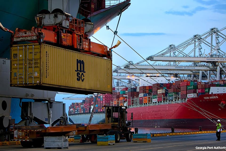 Image of a shipping container about to be loaded onto a cargo ship