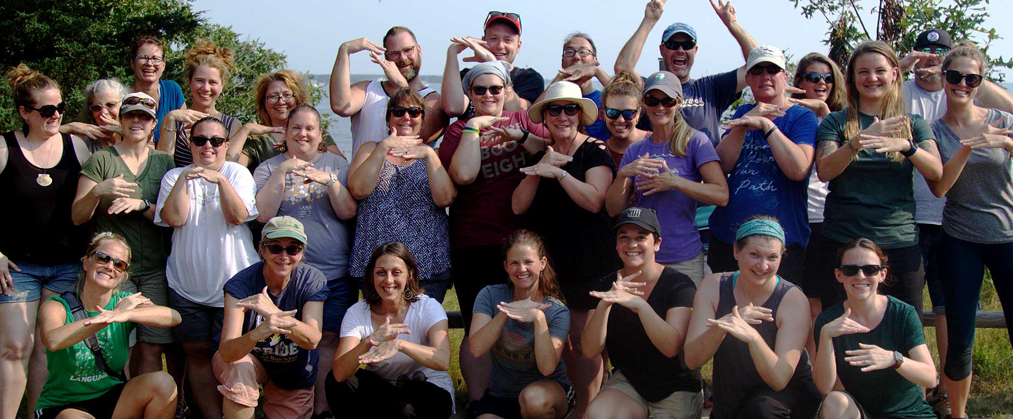 Attendees of a Teachers on the Estuary workshop at Waquoit Bay Reserve demonstrate the new ASL sign for estuary, Photo credit: James Rassman