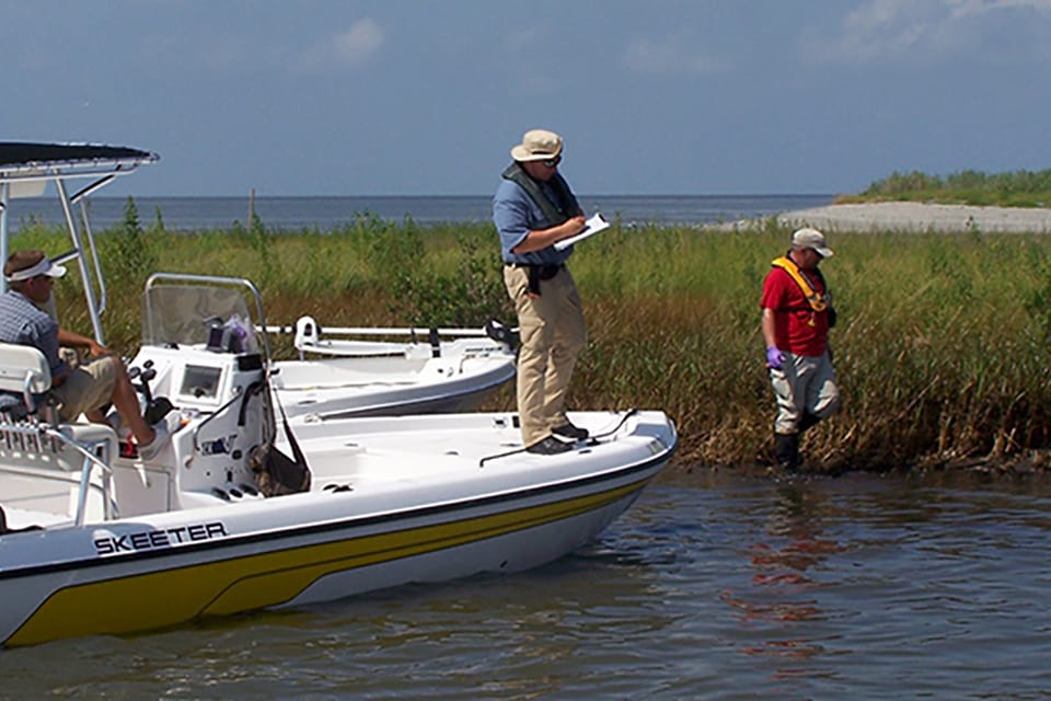 NOAA restoration project team assessing oiling of marshes in Barataria Bay, Lousiana. After an oil spill, NOAA conducts studies to identify the extent of damage, the best methods for restoring natural resources, and the type and amount of restoration required.