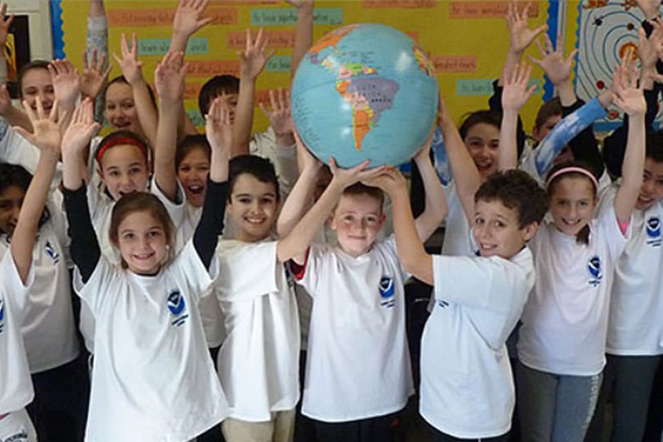 kids holding up a globe