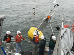 Deploying an oceanographic buoy from a NOAA vessel.