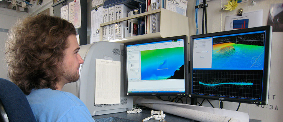a hydrographer at a computer