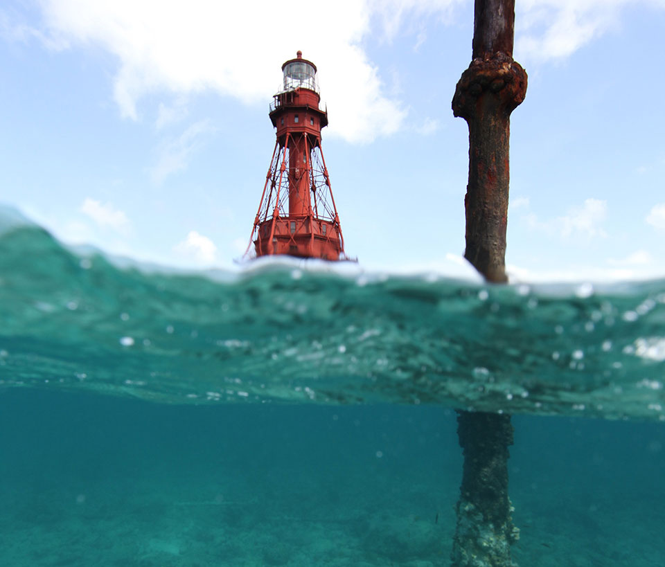 The rusty remnants of a Totten Beacon (foreground) located near American Shoal lighthouse. Photo credit: M. Lawrence.
