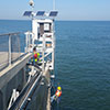 Staff install the final components on the NOAA water level station on the Chesapeake Bay Bridge Tunnel