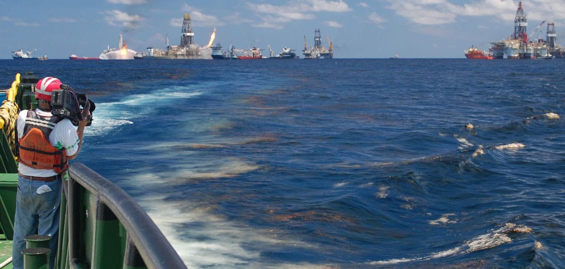  National Geographic videographer Bob Perrin films an oil slick at the Deepwater Horizon site. Image credit: NOAA. 