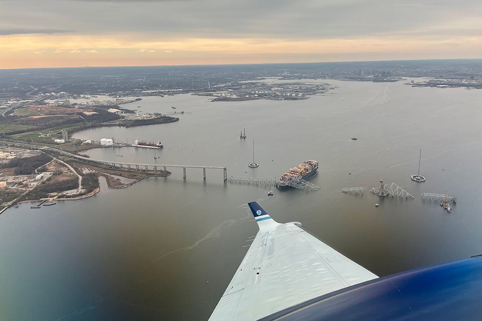 March 28, 2024: View from NOAA King Air N68RF aircraft during a navigation survey following the collapse of the Francis Scott Key Bridge in Baltimore. The bridge and the MV Dali, the container ship which collided into it, are visible. (Image credit: Lt. Eric Fritzsche/NOAA Corps)