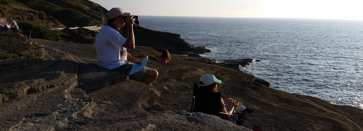 people looking for whales with binoculars