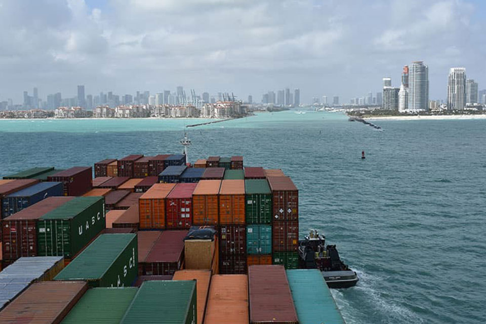A container ship enters the shipping channel at Port Miami