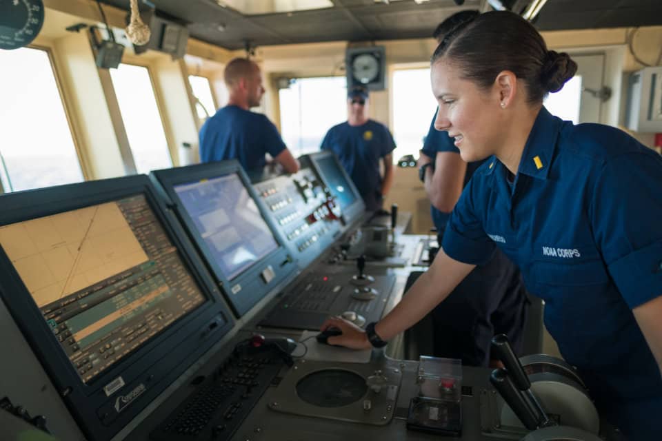 ENS Brianna Pacheco using the ship's Electronic Chart Display Information System to navigate the ship. ECDIS is a navigation app that includes electronic navigation charts and other tools.
