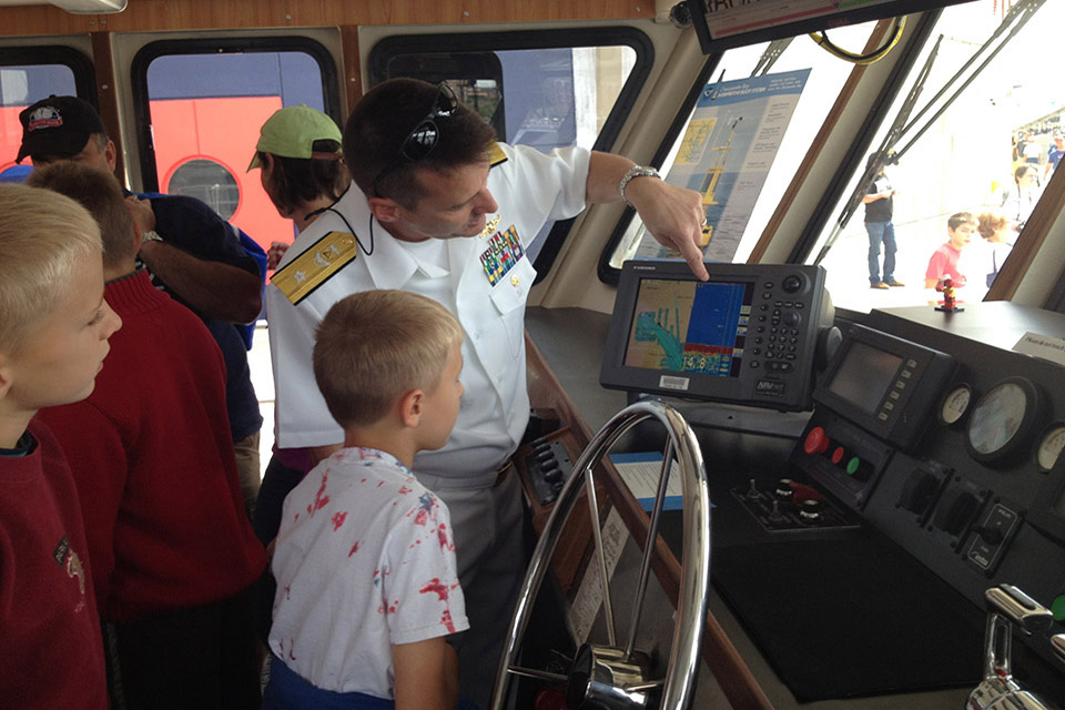 Rear Admiral Gerd Glang introduces kids to nautical charts onboard R/V Bay Hydro II.
