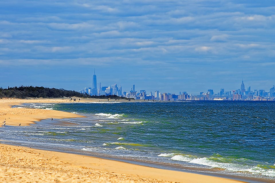 a New Jersey beach with a view of the New York City skyline