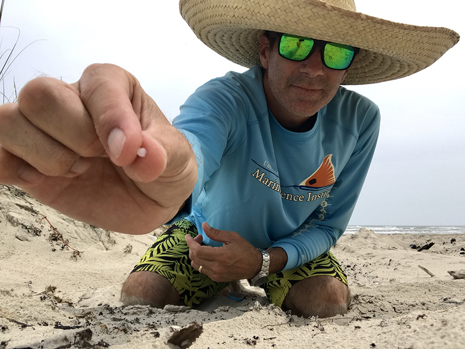 Jace Tunnell, Director of the Mission Aransas National Estuarine Research Reserve, holds a nurdle in his hand. Photo Credit: Jace Tunnell.