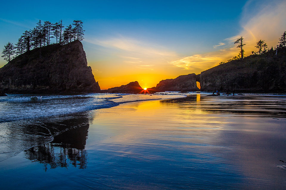a beautiful sunrise on a West Coast beach with high cliffs